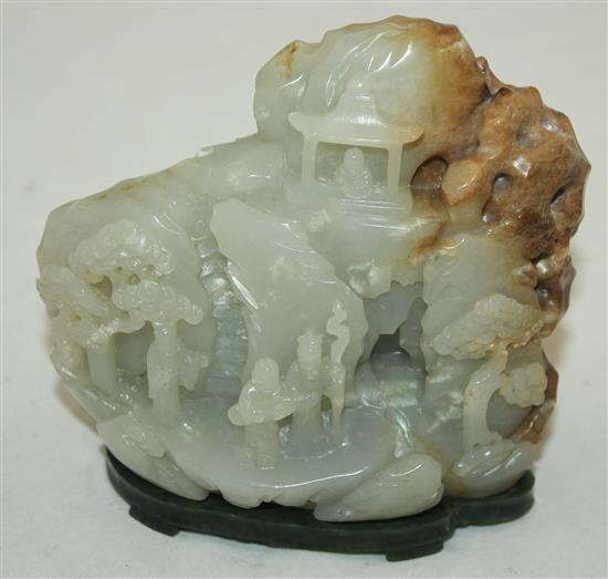 A Chinese pale celadon and russet jade boulder carving, height 10cm